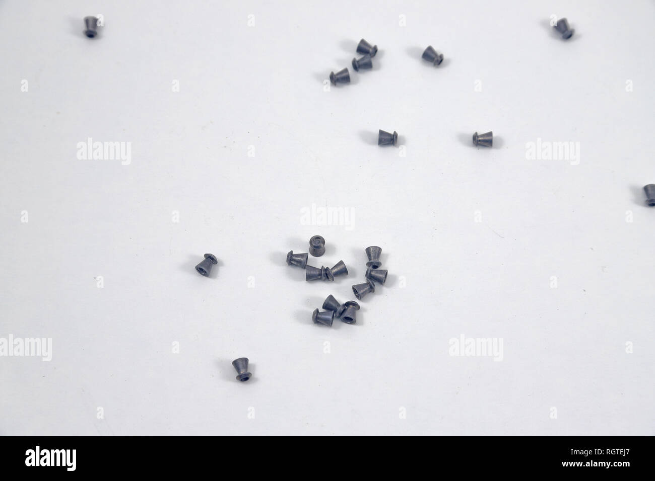 Air Rifle pellets used for hunting and sport, scattered on a white background Stock Photo