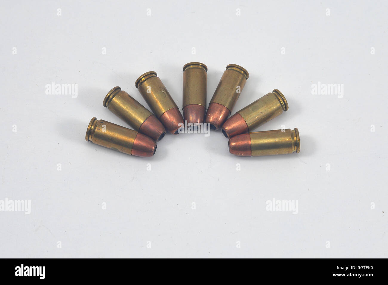 Pistol ammo used in semi-auto pistol, arranged on a white background Stock Photo