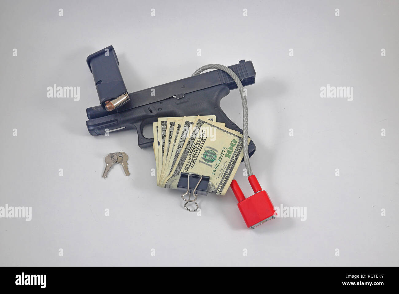 GUn locked with magazine with ammo, cash, bullets, keys Stock Photo Alamy