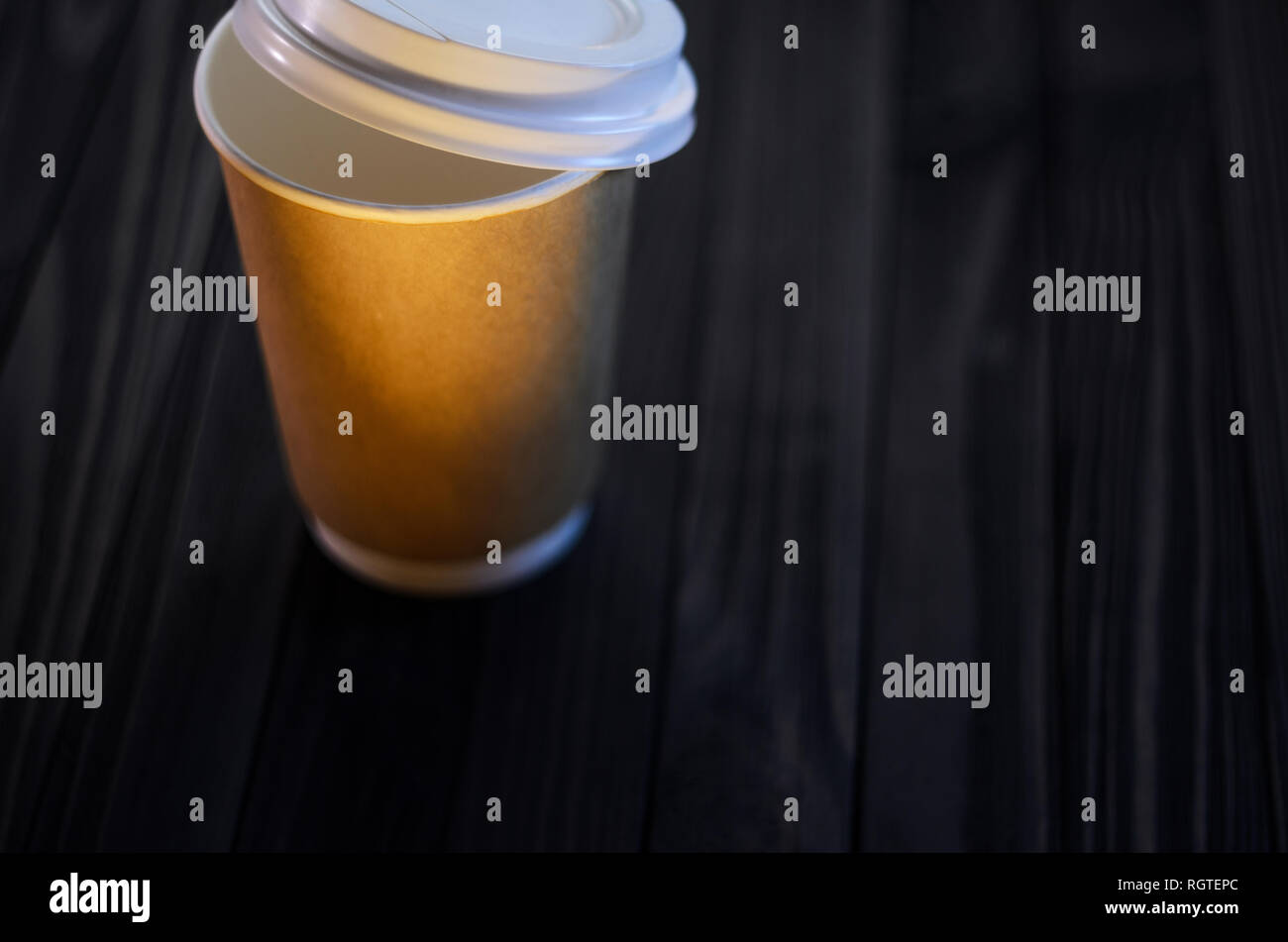 A cup of coffee on the table. Paper cup Wooden table Plastic cap Coffee Expectation. Coffee take