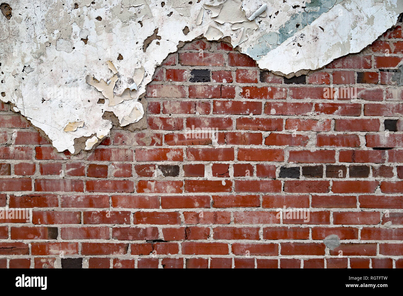 Old Vintage painted Brick and mortar wall with plaster and pealing
