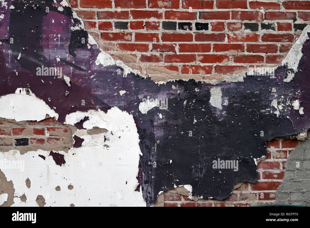 Old Vintage painted Brick and mortar wall with purple plaster and pealing paint, background texture Stock Photo