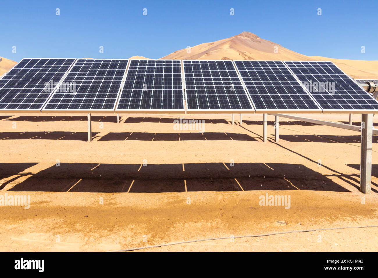 Hundreds solar energy modules or panels rows along the dry lands at Atacama Desert, Chile. Huge Photovoltaic PV Plant in the middle of the desert Stock Photo