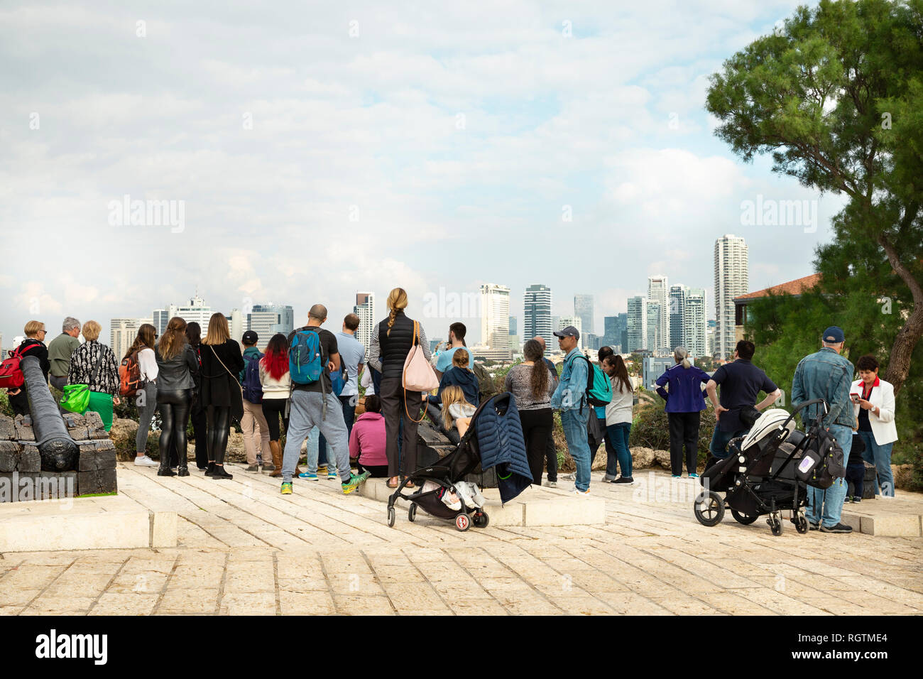 Tel Aviv, Jaffa, Israel - December 23, 2018:A group of  tourists look at the aerial city's panorama from the Glee Hill, Abrasha Park in Old Jaffa Stock Photo