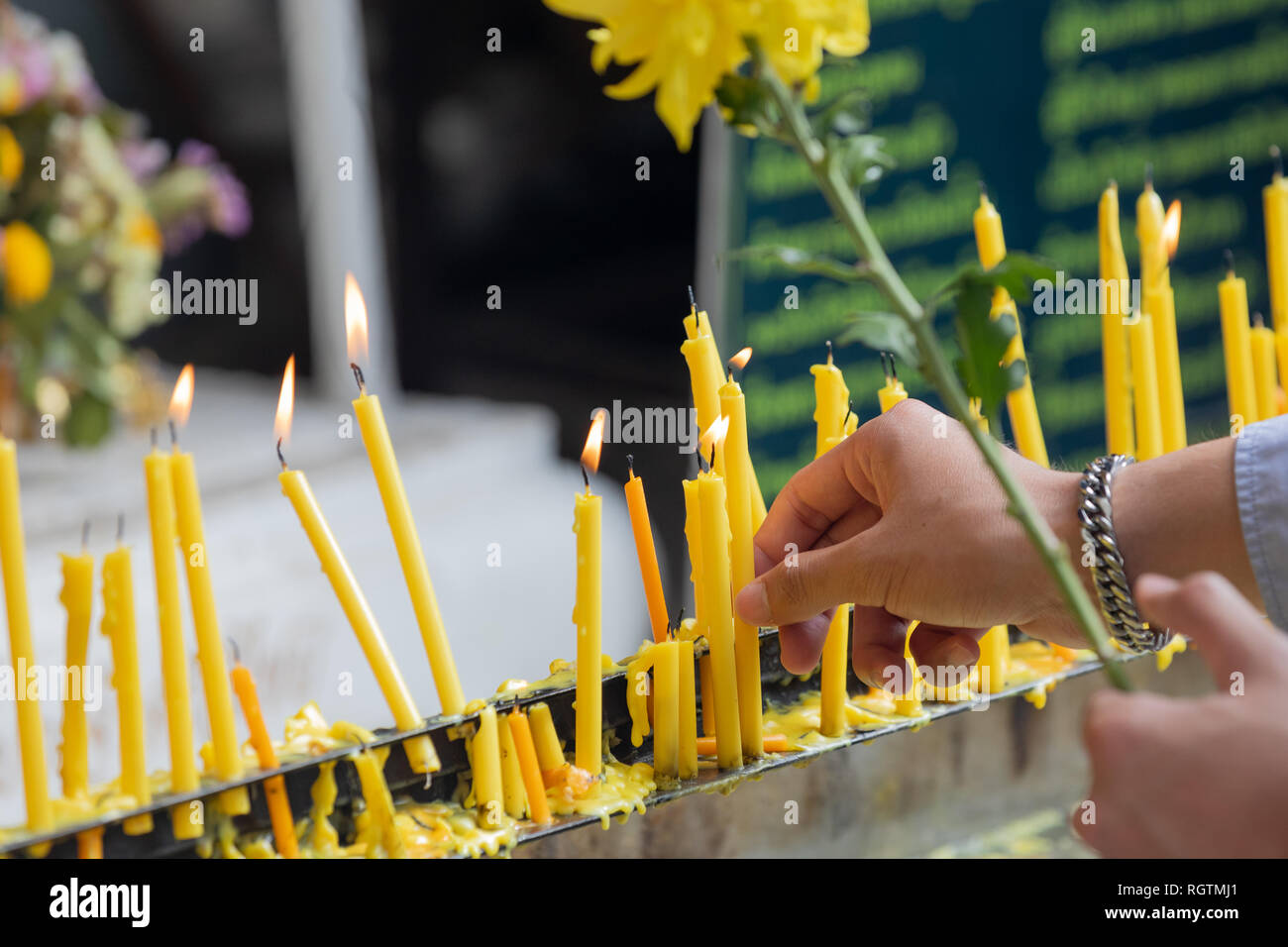 Candles being lit in front of temple Stock Photo Alamy