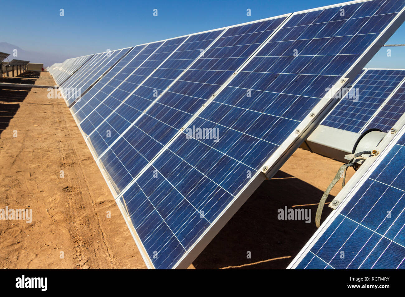 Hundreds solar energy modules or panels rows along the dry lands at Atacama Desert, Chile. Huge Photovoltaic PV Plant in the middle of the desert Stock Photo