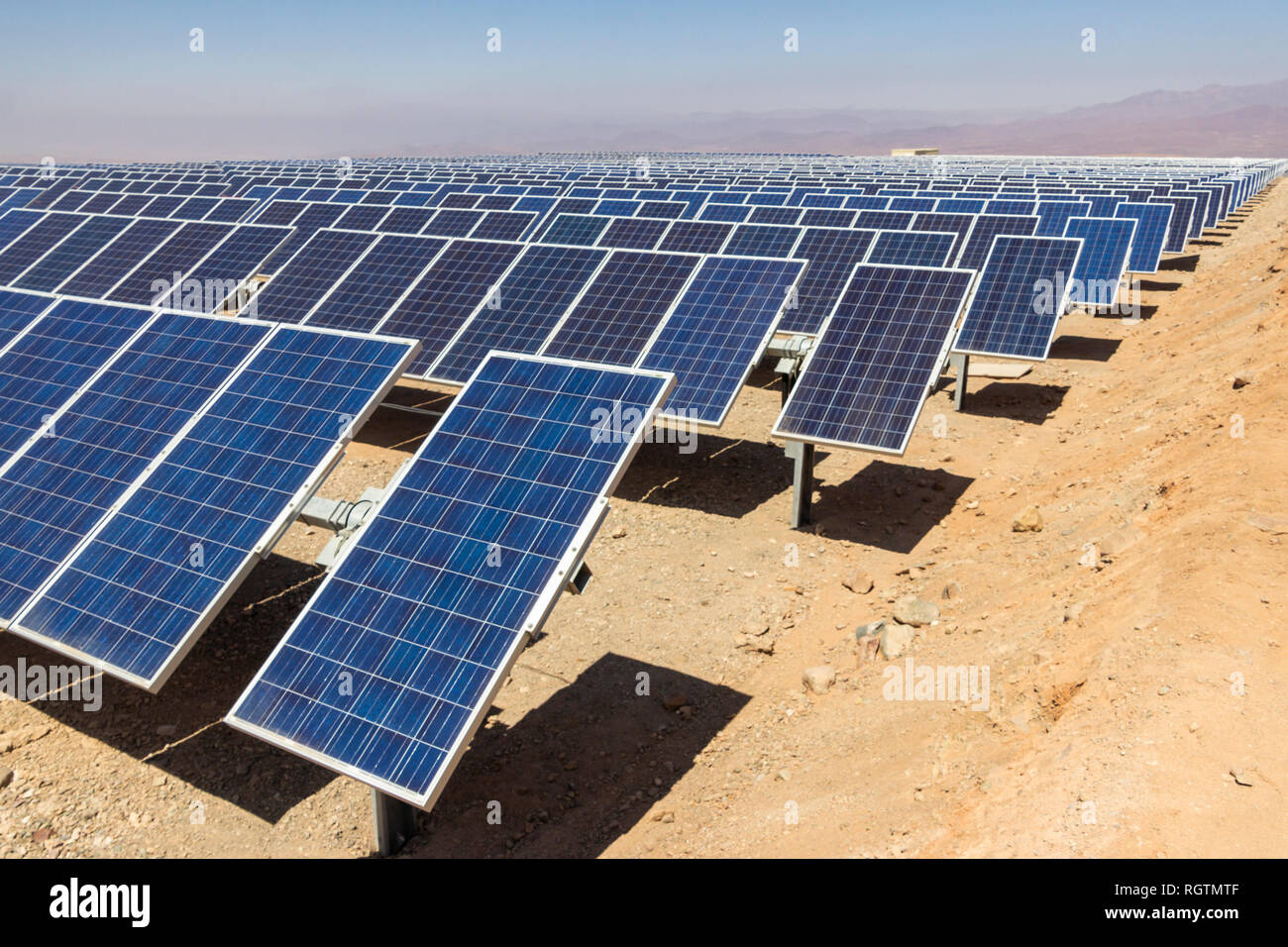 Hundreds solar energy modules or panels rows along the dry lands at Atacama Desert, Chile. Huge Photovoltaic PV Plant in the middle of the desert Stock Photo