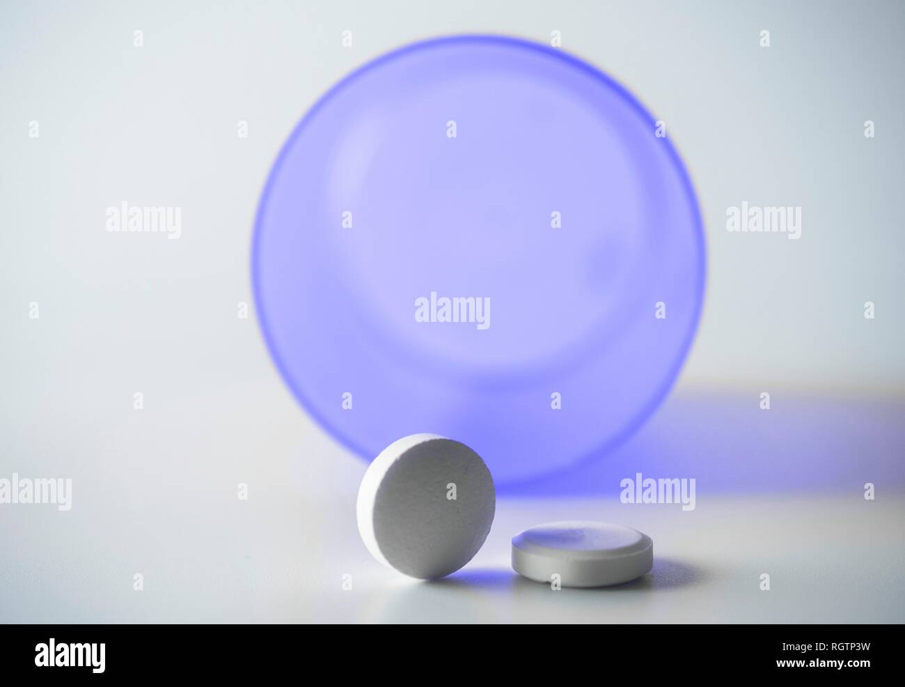 Tablets with isolated bottle on white background, conceptual image Stock Photo