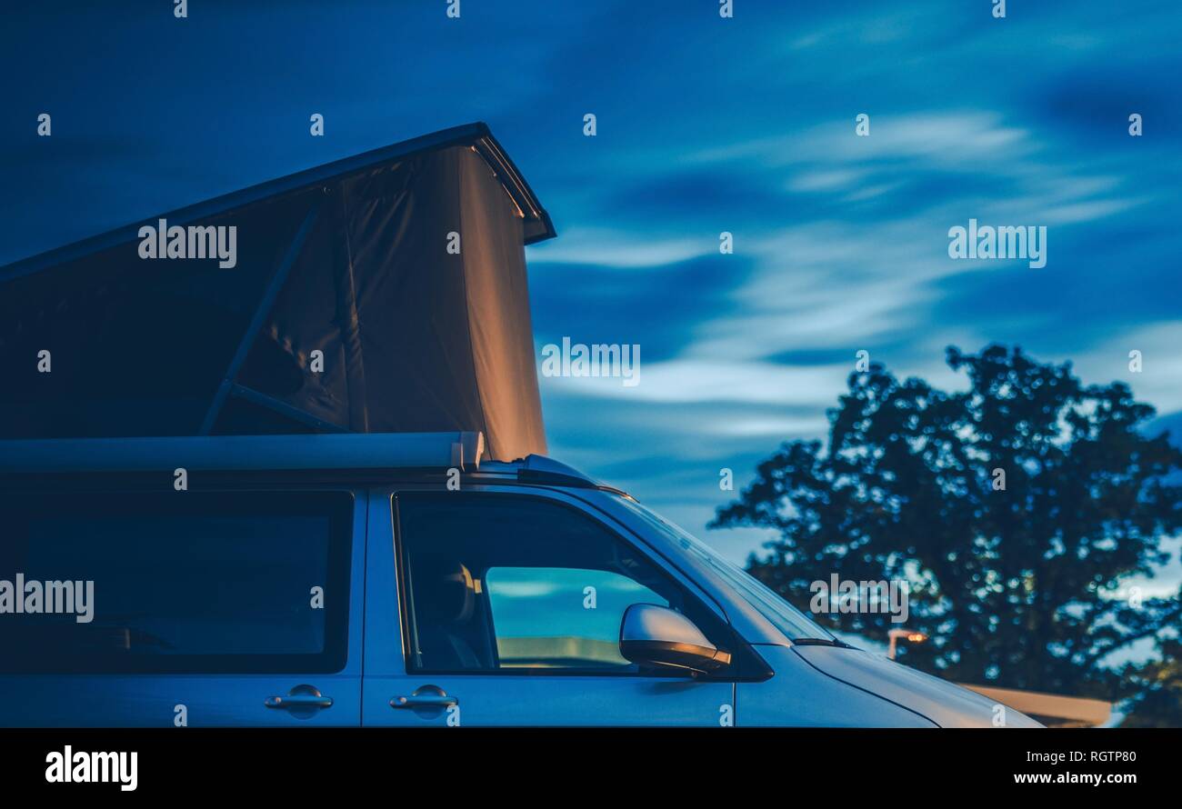 Roof Top Tent Camping. Modern Tent on the Camper Van. Travel Industry. Stock Photo