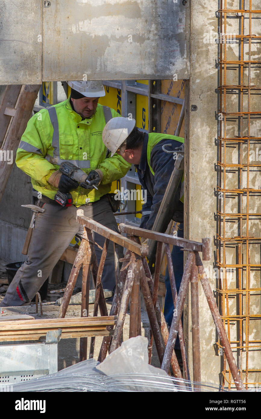 Neuwied, Germany - January 19, 2019: two construction workers are working with a drill bit Stock Photo