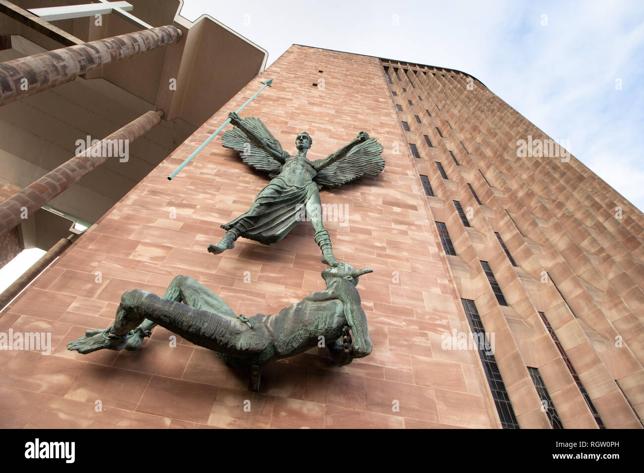 St Michael's victory over the Devil is portrayed in this statue by Sir Jacob Epstein, mounted on the side of the new Coventry Cathedral. Stock Photo