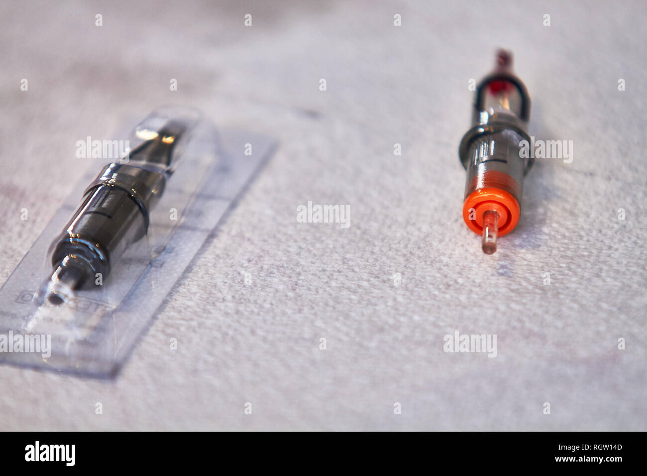 Tattoo machine needle packaged and unpackaged Stock Photo Alamy