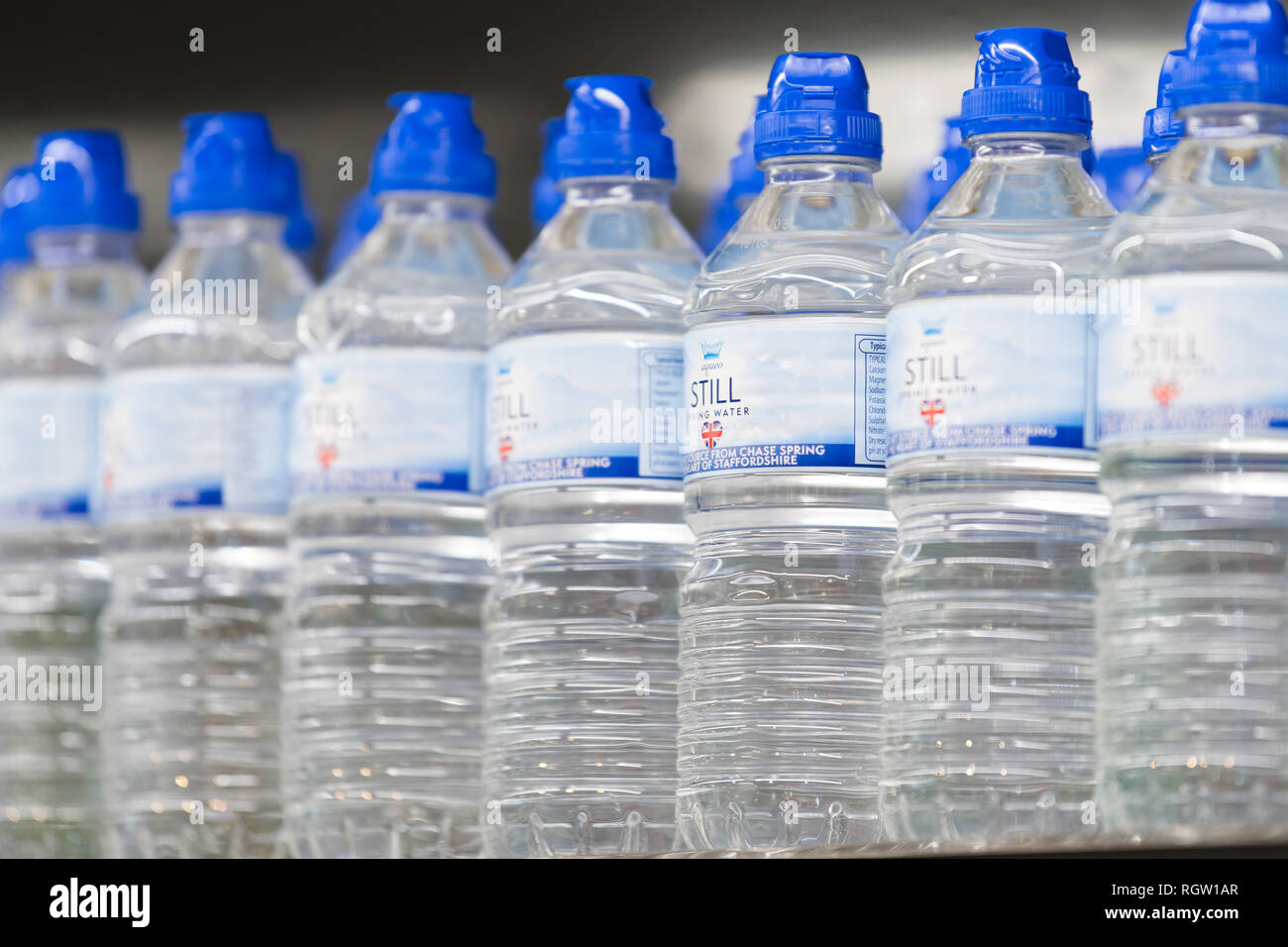 Bottles of still spring water on sale in a supermarket in the UK. Stock Photo