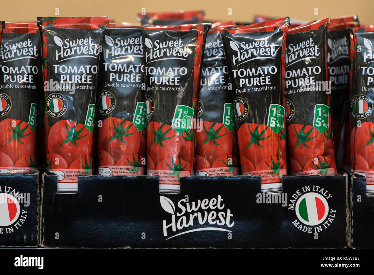 A selection of tubes of tomato purée on sale in a supermarket in the UK