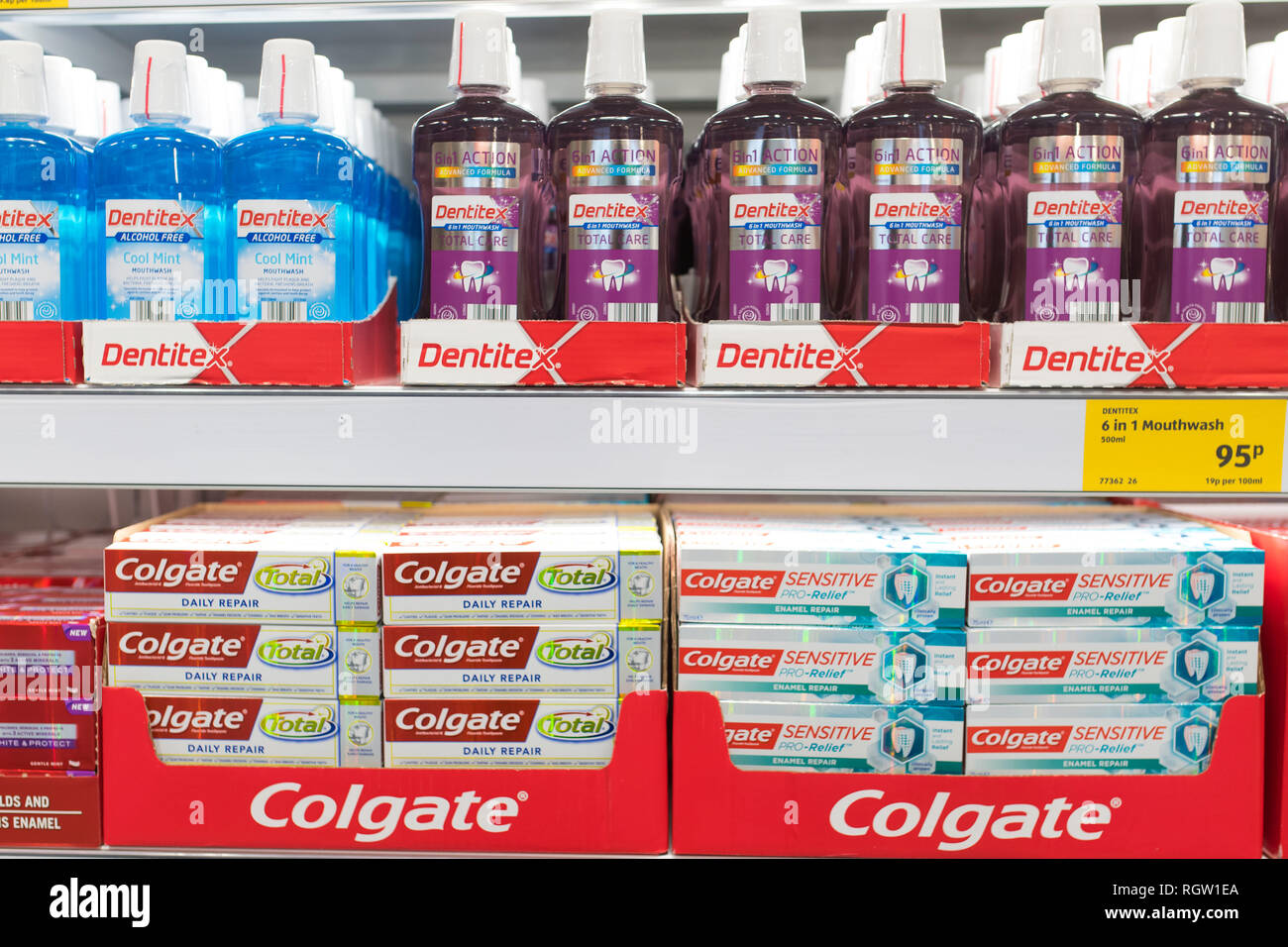 Bottles of dental hygiene products - mouthwash and Colgate toothpaste on  sale on a shelf in a supermarket Stock Photo - Alamy