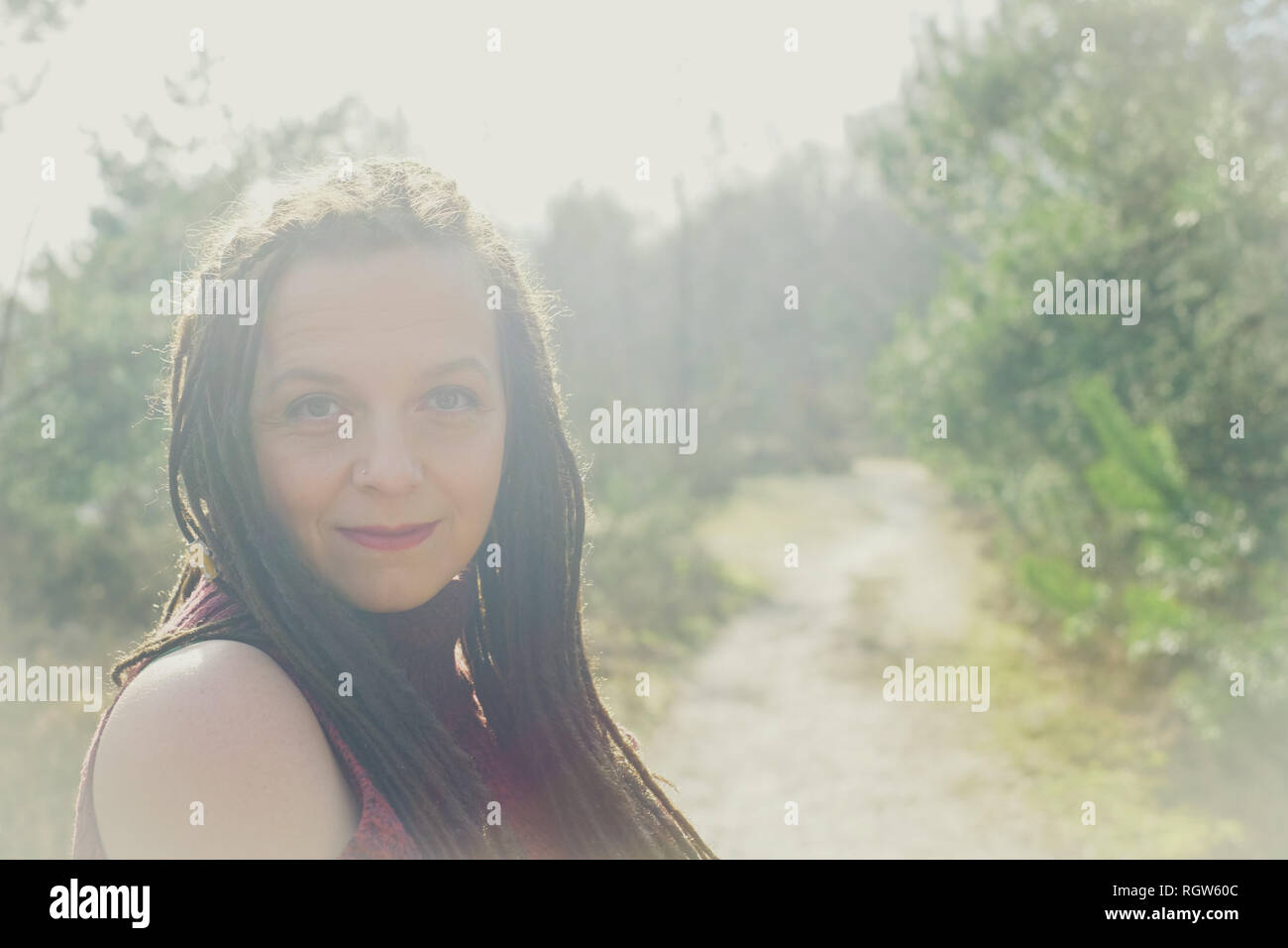 Serene woman sitting in a sunny haze Stock Photo