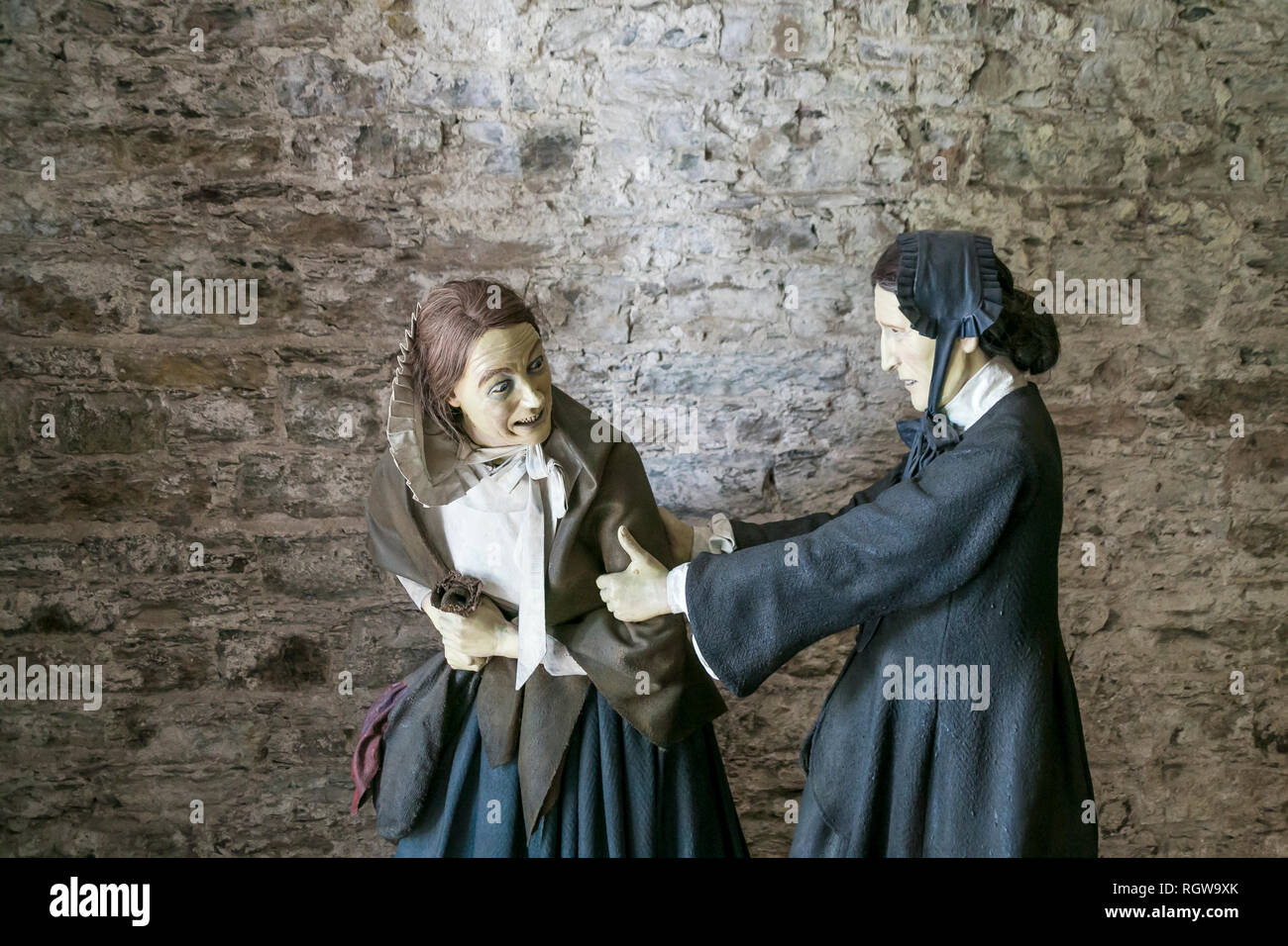 Models of female prisioner and warder in entrance to Cork City Gaol, Cork, Ireland. Stock Photo