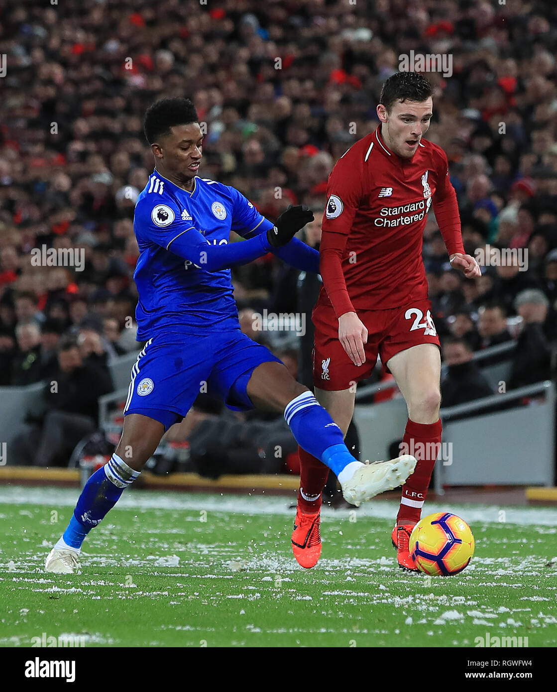 Leicester City's Demarai Gray and Liverpool's Andrew Robertson battle for the ball during the Premier League match at Anfield, Liverpool. Stock Photo