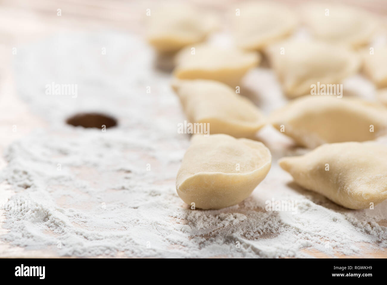 Raw dumplings ready to boil, close up, with copy space. Also known as Vareniks, Ukrainian traditional cuisine Stock Photo
