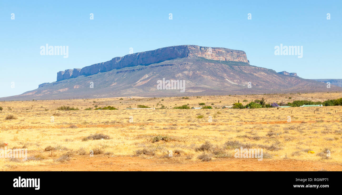 Dusty evening Karoo landscape with flat topped mesas formed by erosion leaving dolerite or ironstone strata in semi desert plains, Karoo, Northern Cap Stock Photo