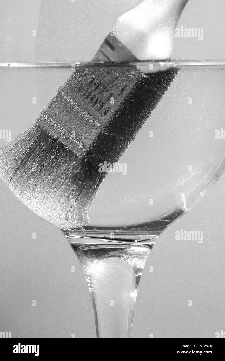 paintbrush in large wine glass Stock Photo
