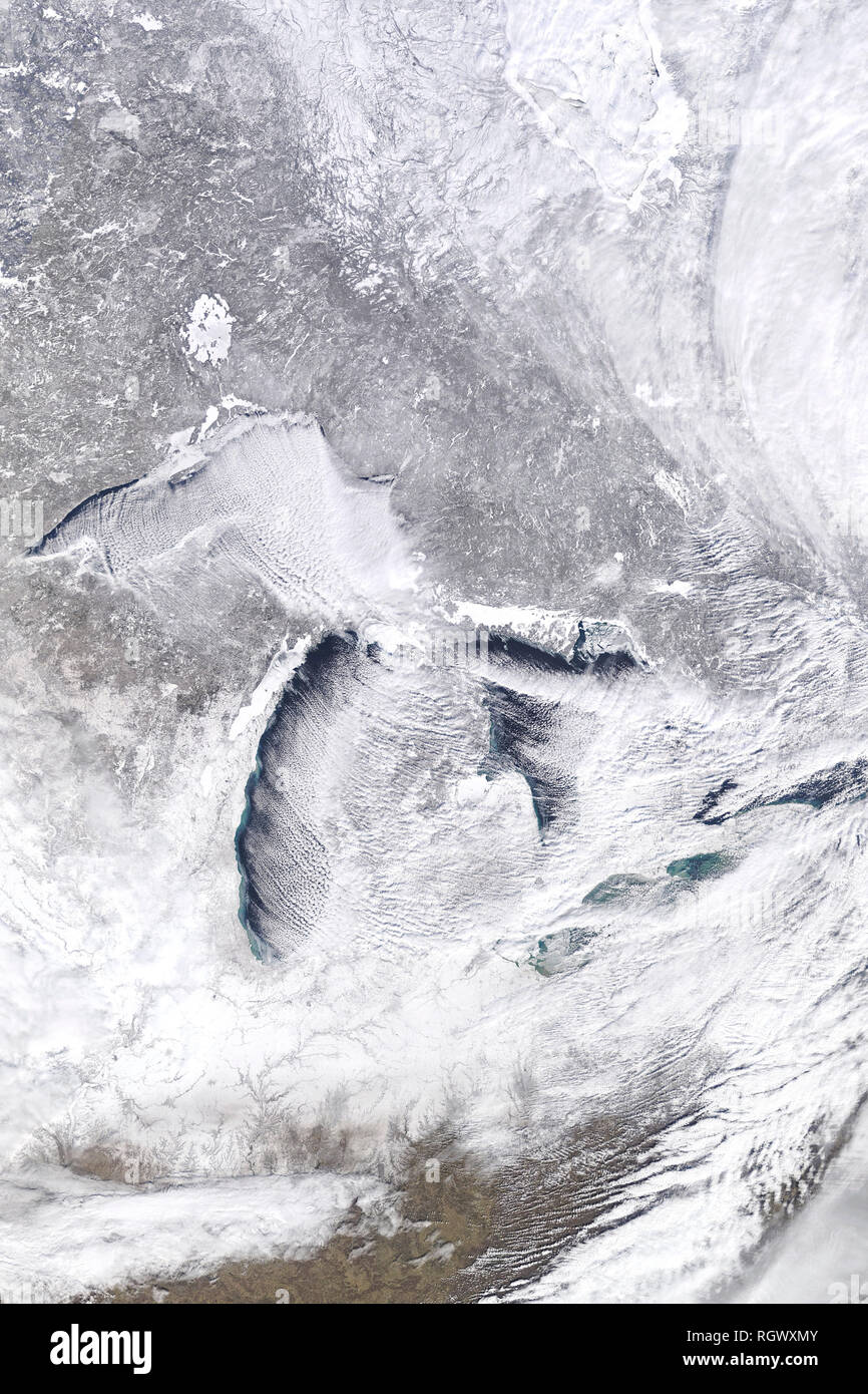 Cloud streets and lake-effect snow stretch across the scene, as frigid Arctic winds blew over the Great Lakes. Stock Photo