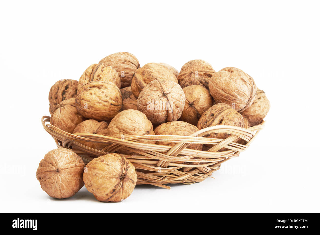 walnuts in a basket on a white background Stock Photo