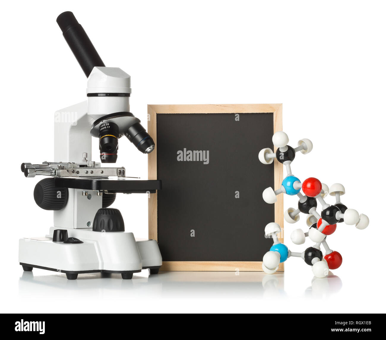 Blank, empty, black chalkboard with microscope and molecule model over white background - science teaching concept Stock Photo