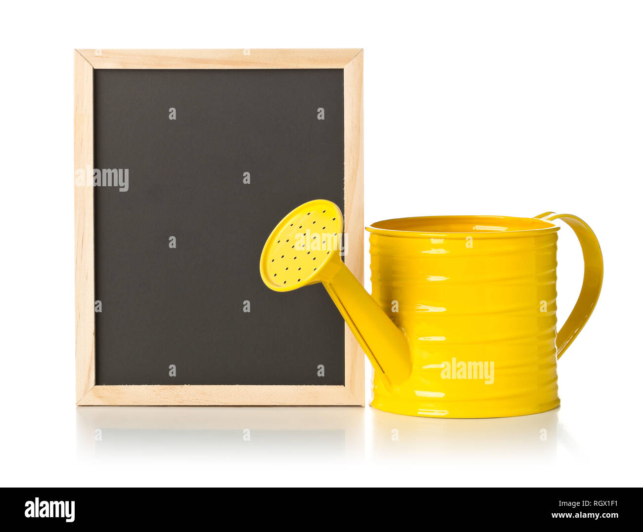 Yellow watering can with empty, blank, black chalkboard over white