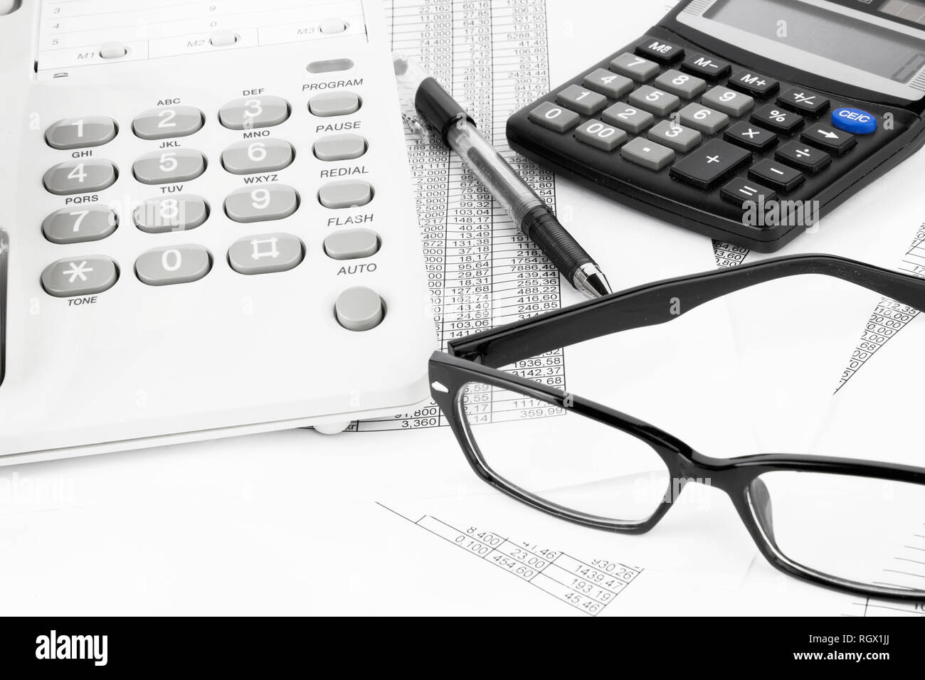 calculator and pen on a business background Stock Photo - Alamy