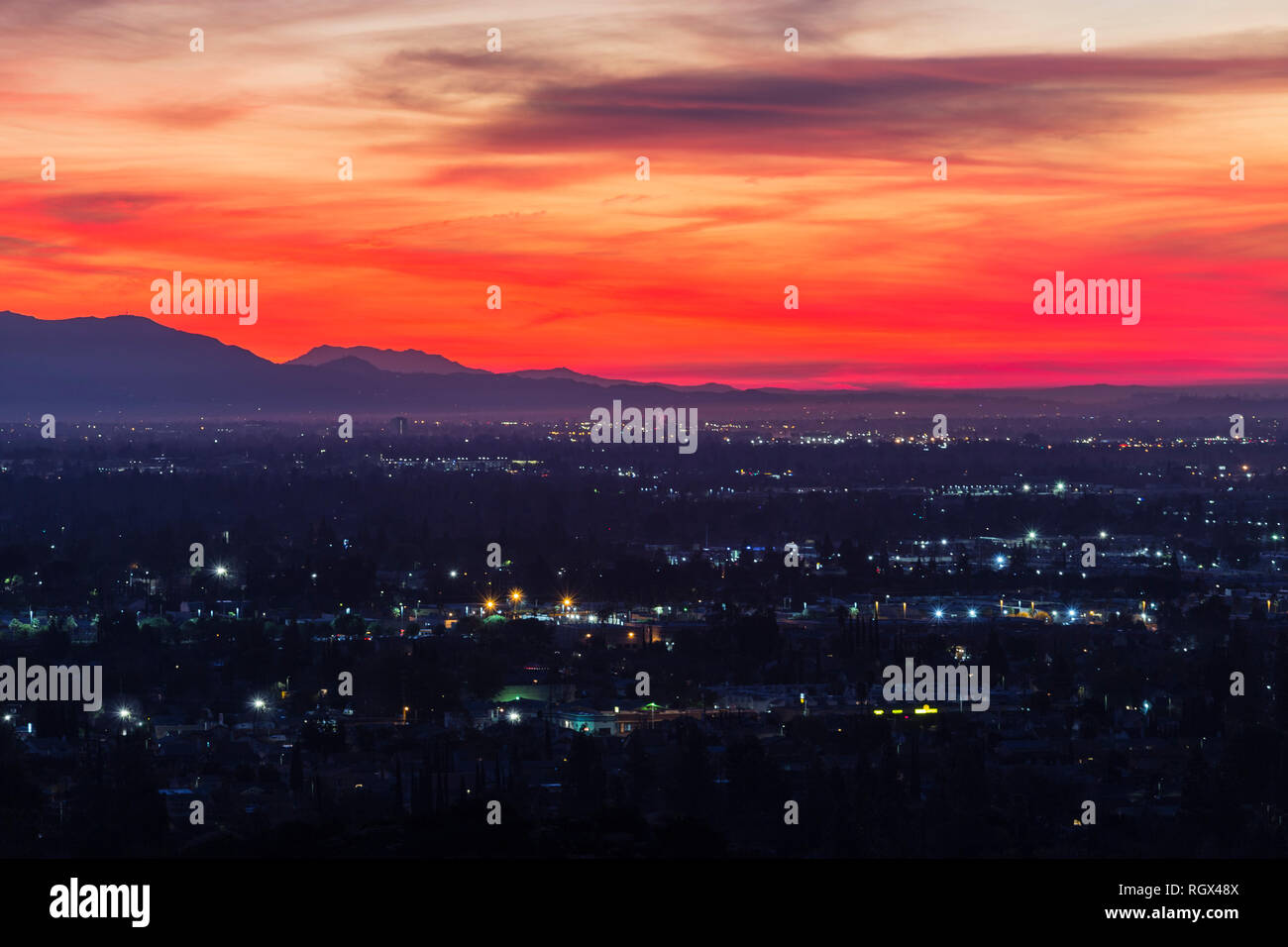 Colorful predawn view of San Fernando Valley neighborhoods and the San Gabriel Mountains in the city of Los Angeles, California. Stock Photo