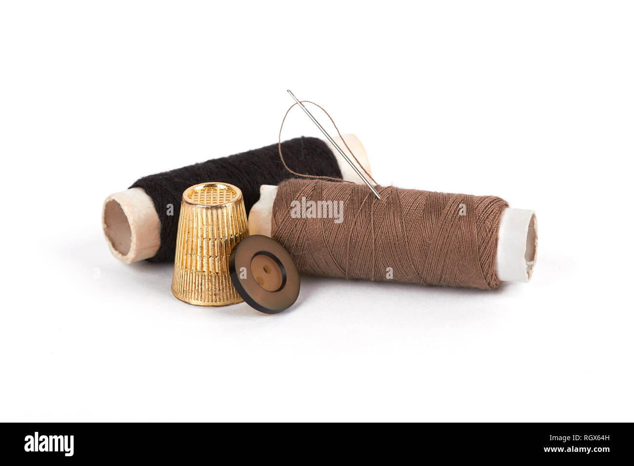thread, needle, button and thimble on isolate white  background Stock Photo