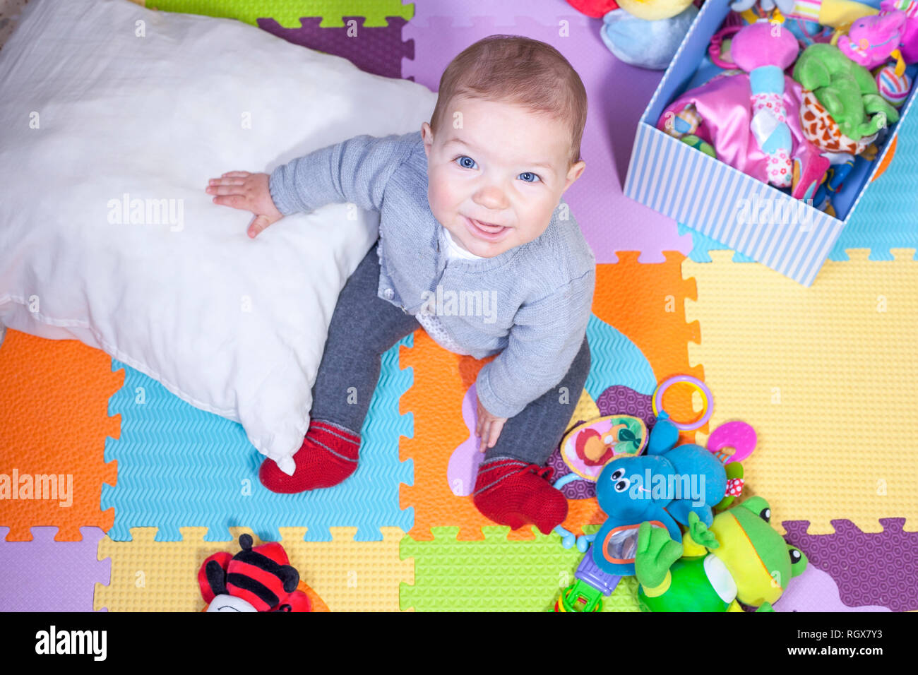 7 months baby boy sitting over puzzle play mat. Learning to sit up concept Stock Photo Alamy