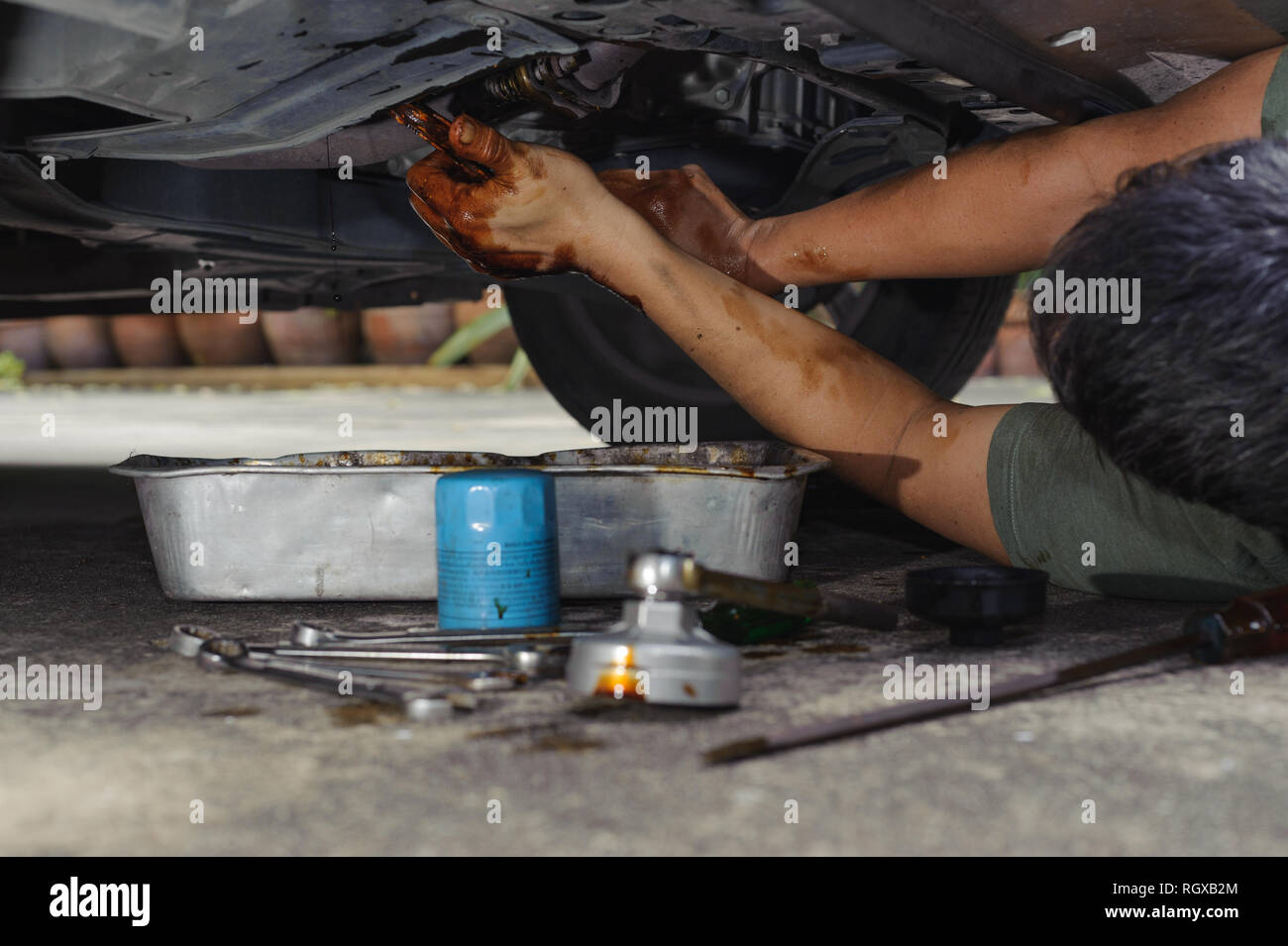 Car mechanic loosen oil filter Stock Photo Alamy