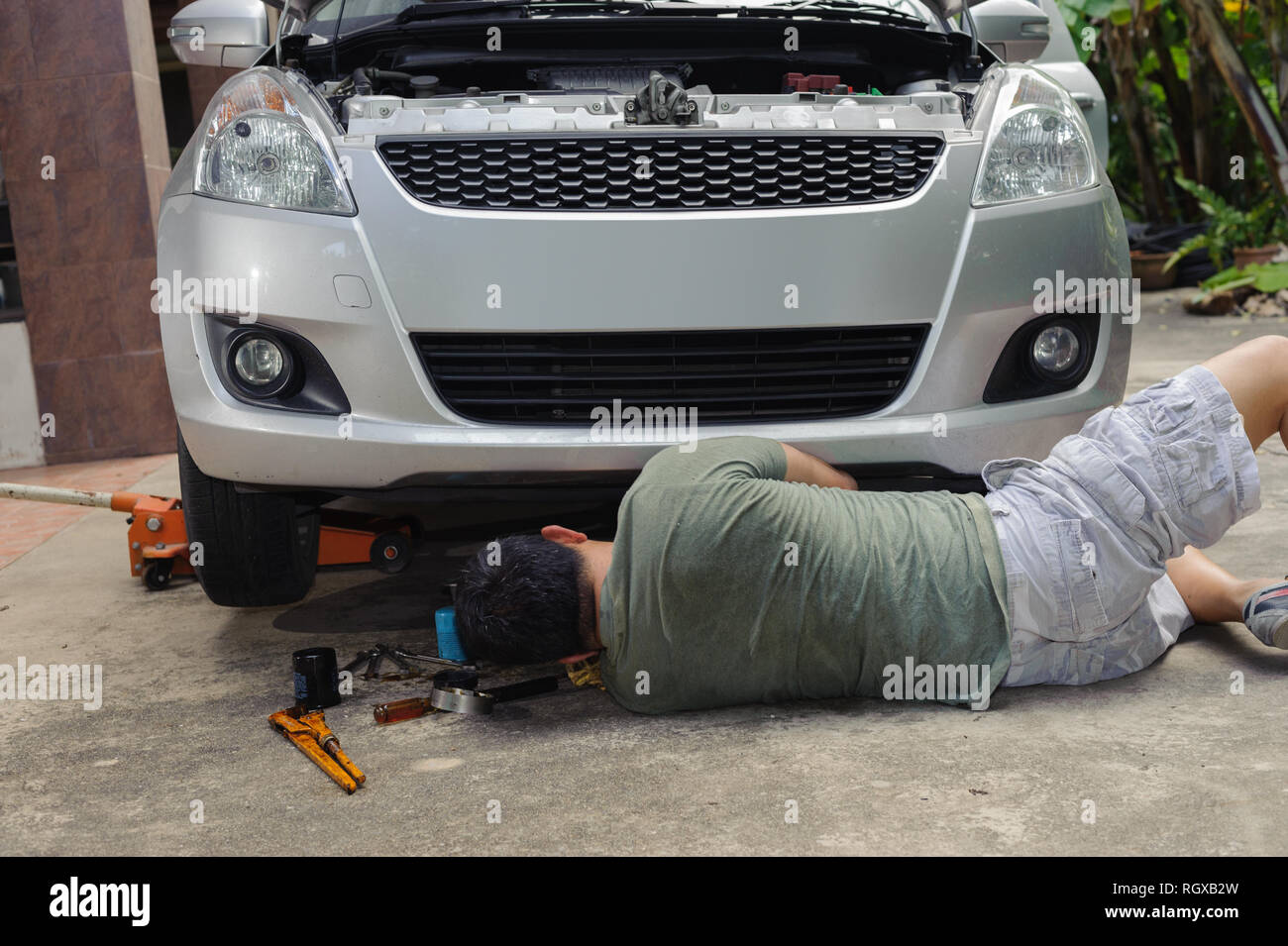 Car mechanic loosen oil filter Stock Photo Alamy