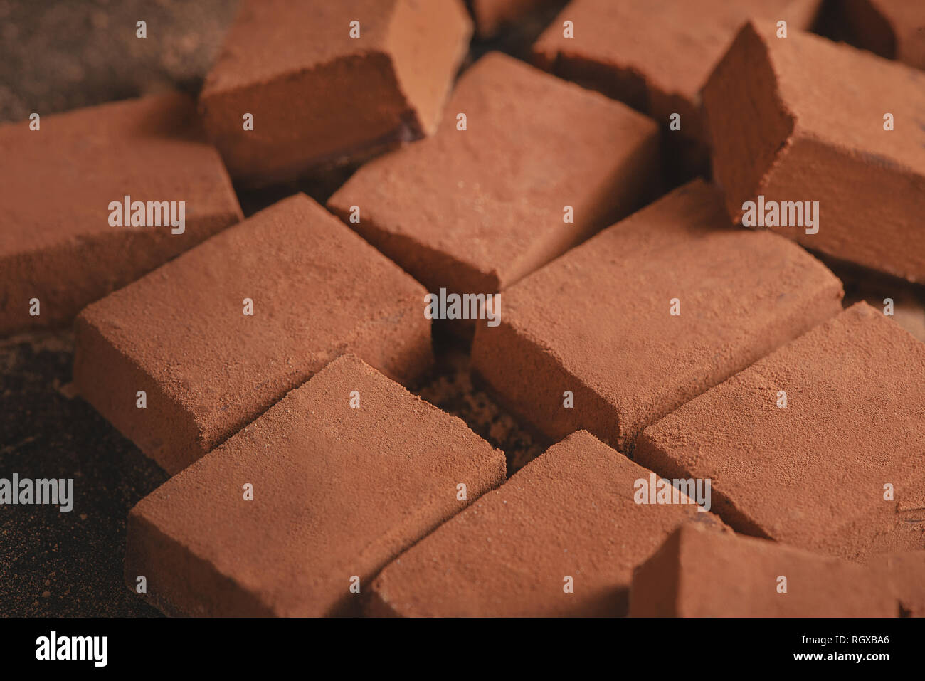 Cocoa powder texture close-up. Soft chocolates on a black background with copy space. Stock Photo