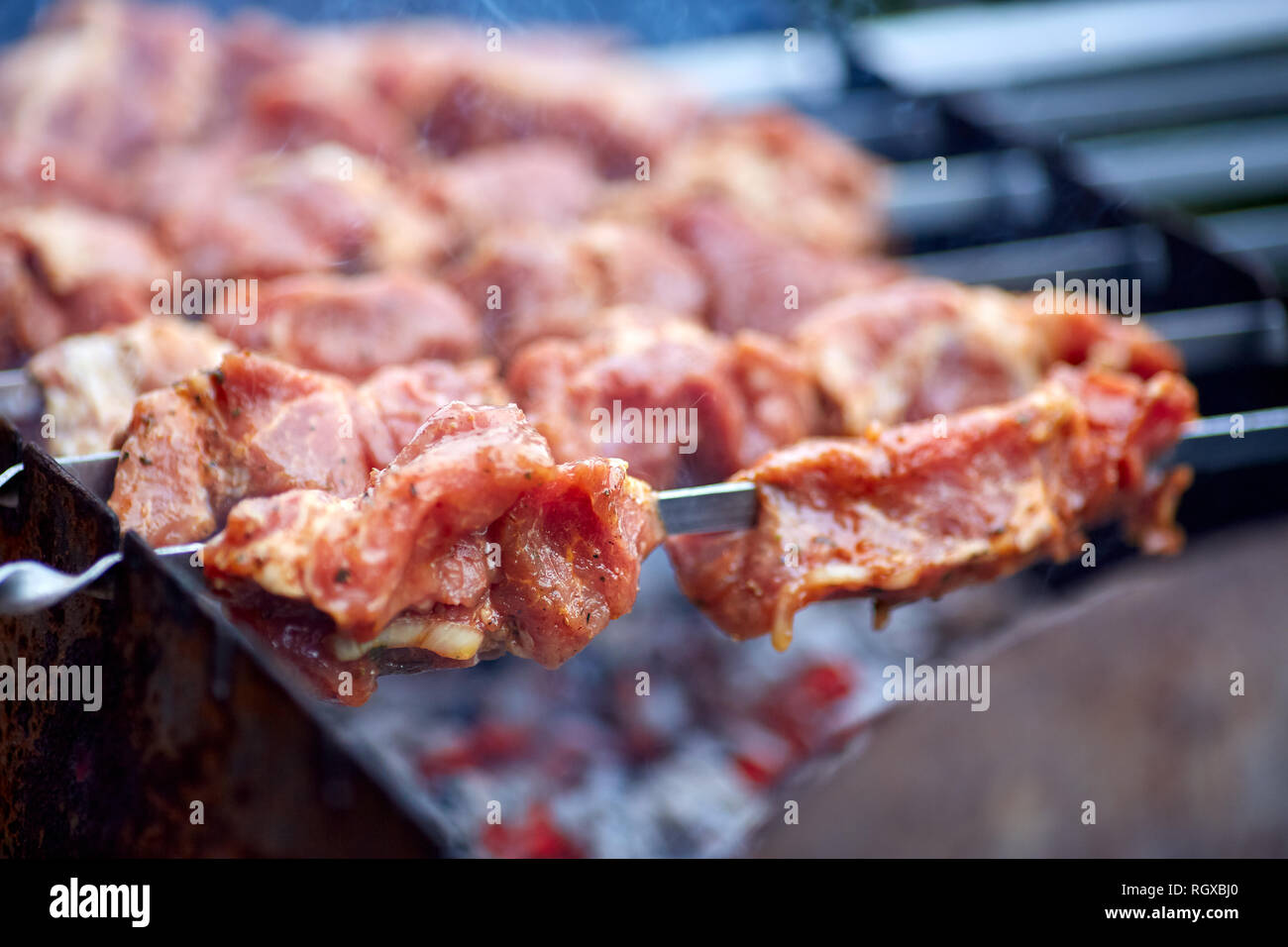 Grilled kebab cooking on metal skewers grill Stock Photo Alamy