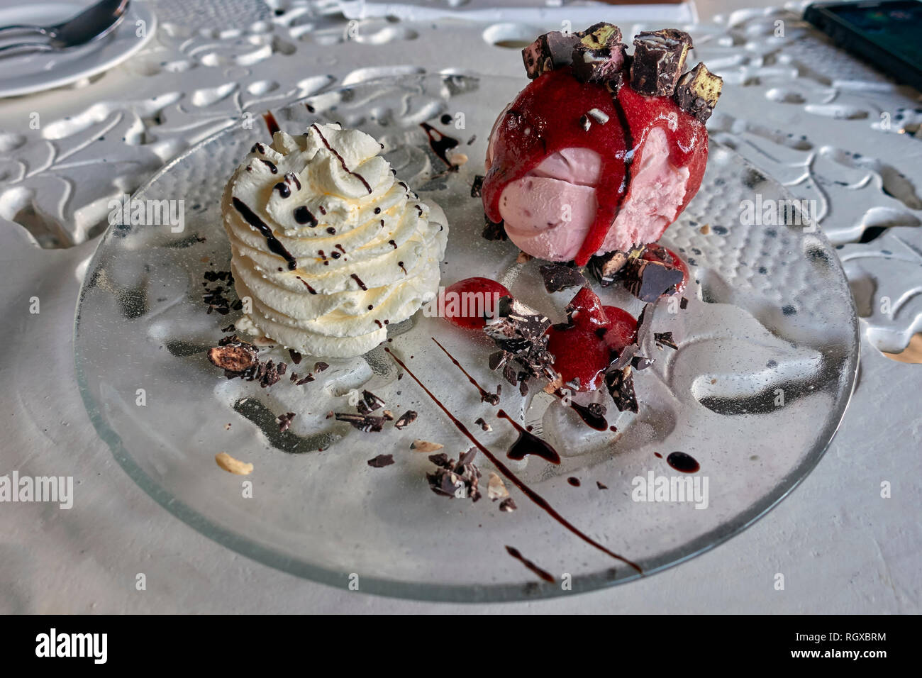 Ice cream with sauce and chocolate crunch topping Stock Photo Alamy