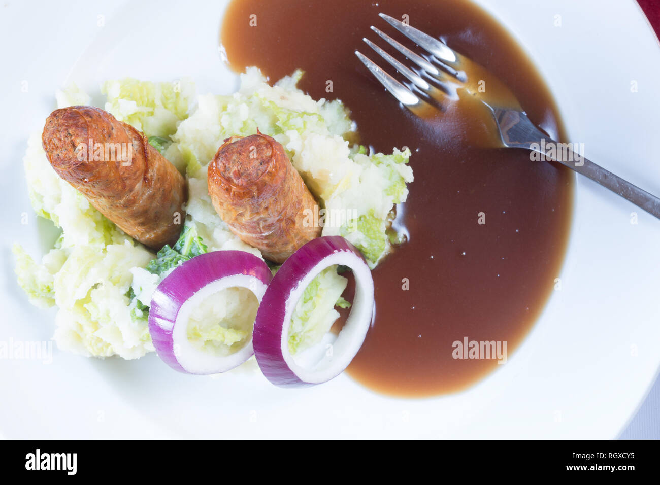 Classic English pub dish of Sausage and mash with gravy sauce Stock