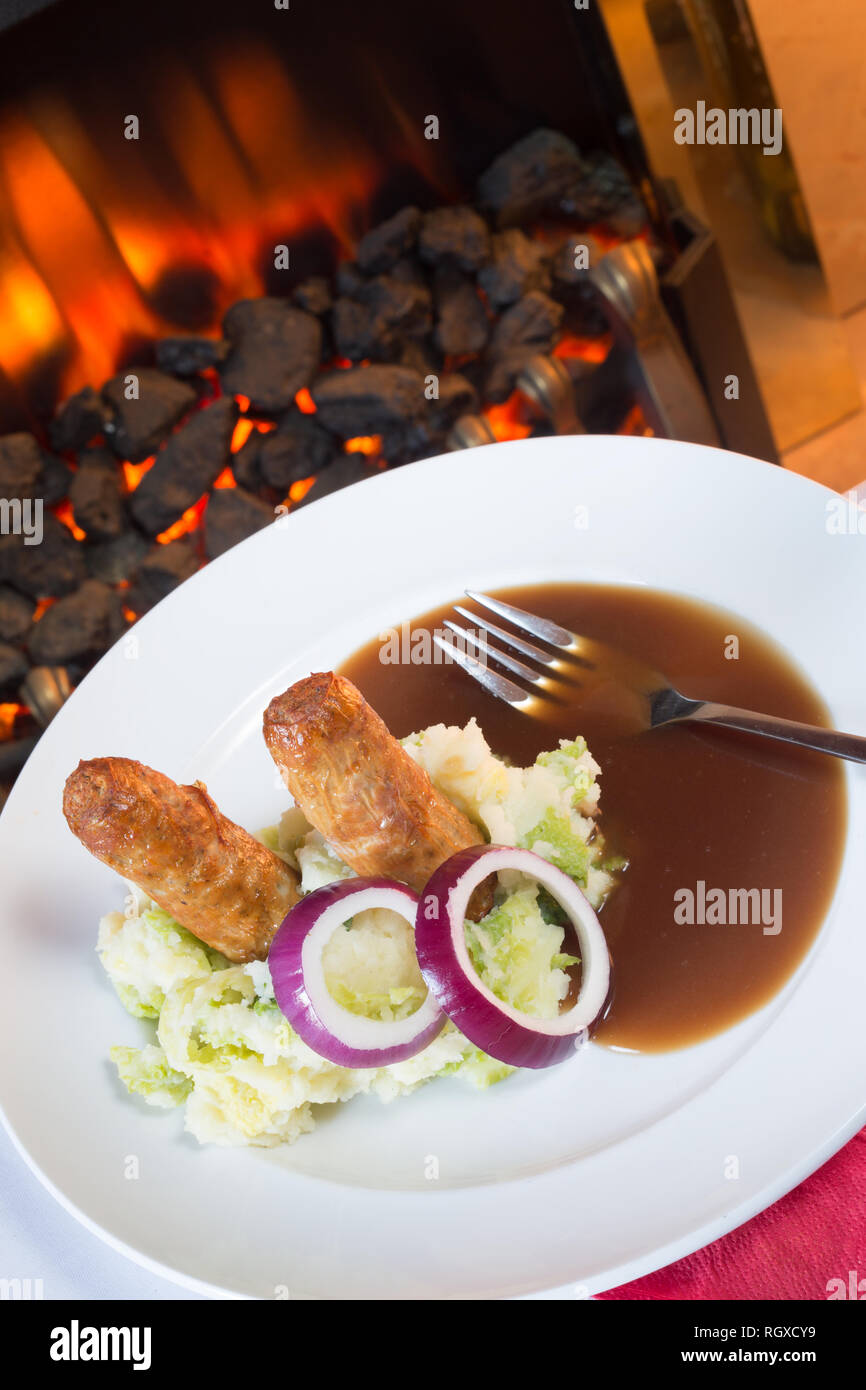 Classic English pub dish of Sausage and mash with gravy sauce Stock