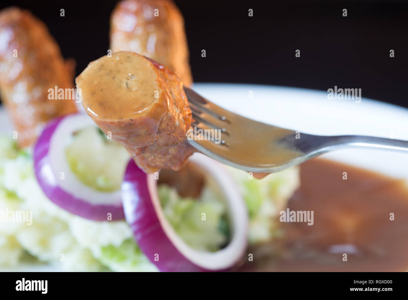 Classic English pub dish of Sausage and mash with gravy sauce Stock