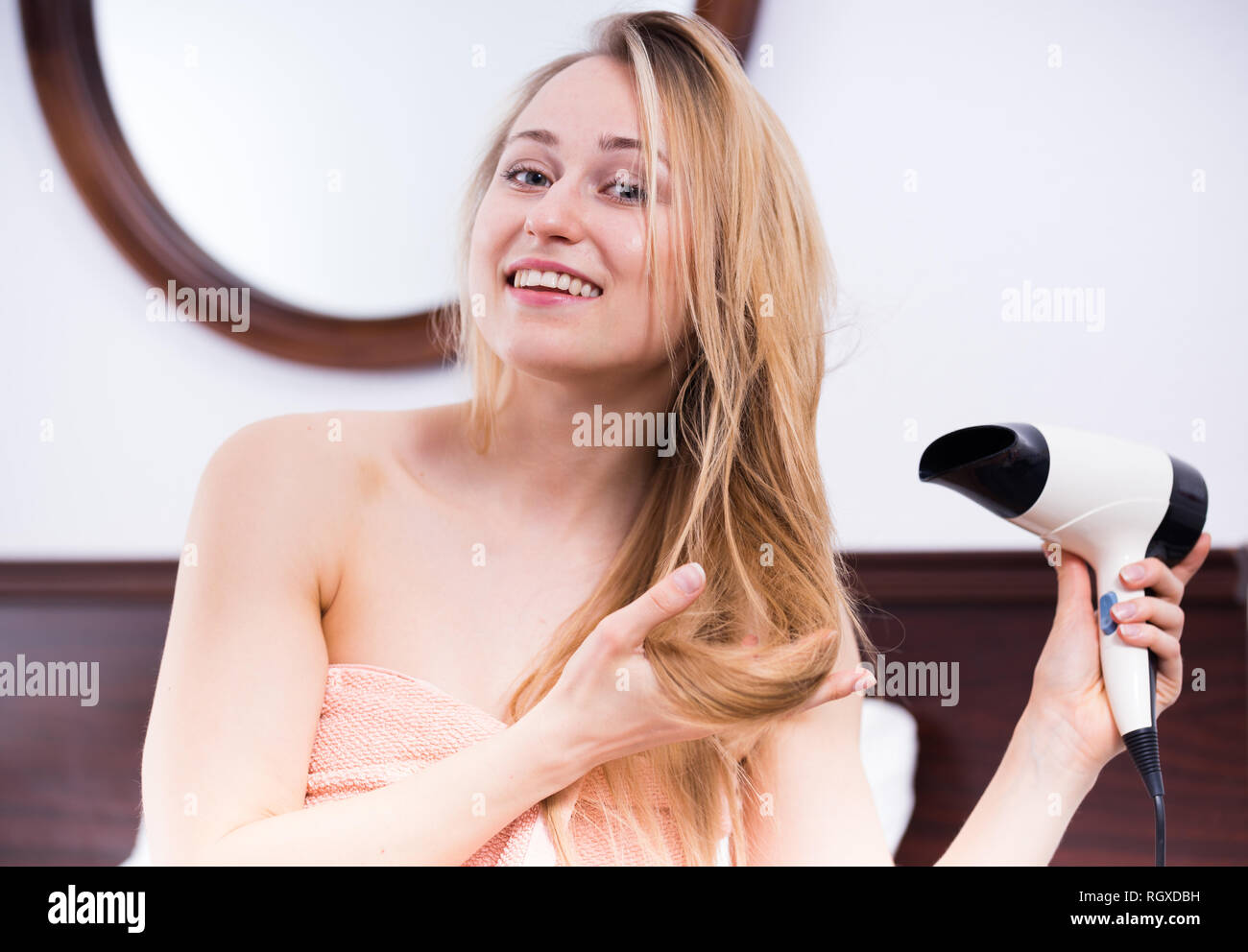 cheerful young woman using hairdryer to style her hair after shower Stock Photo - Alamy cheerful young woman using hairdryer to style her hair after shower Stock Photo - Alamy