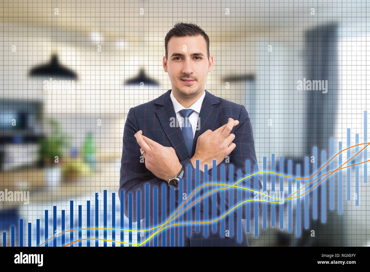 Hopeful broker at stock market using fingers to make good luck gesture on background made out of room and increasing graph Stock Photo