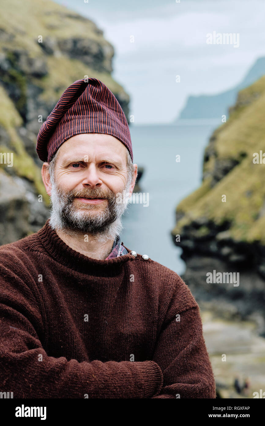 A Faroe islander wearing a traditional Faroese wool sweater and hat in Gjogv Esturoy in the Faroe Islands. Stock Photo