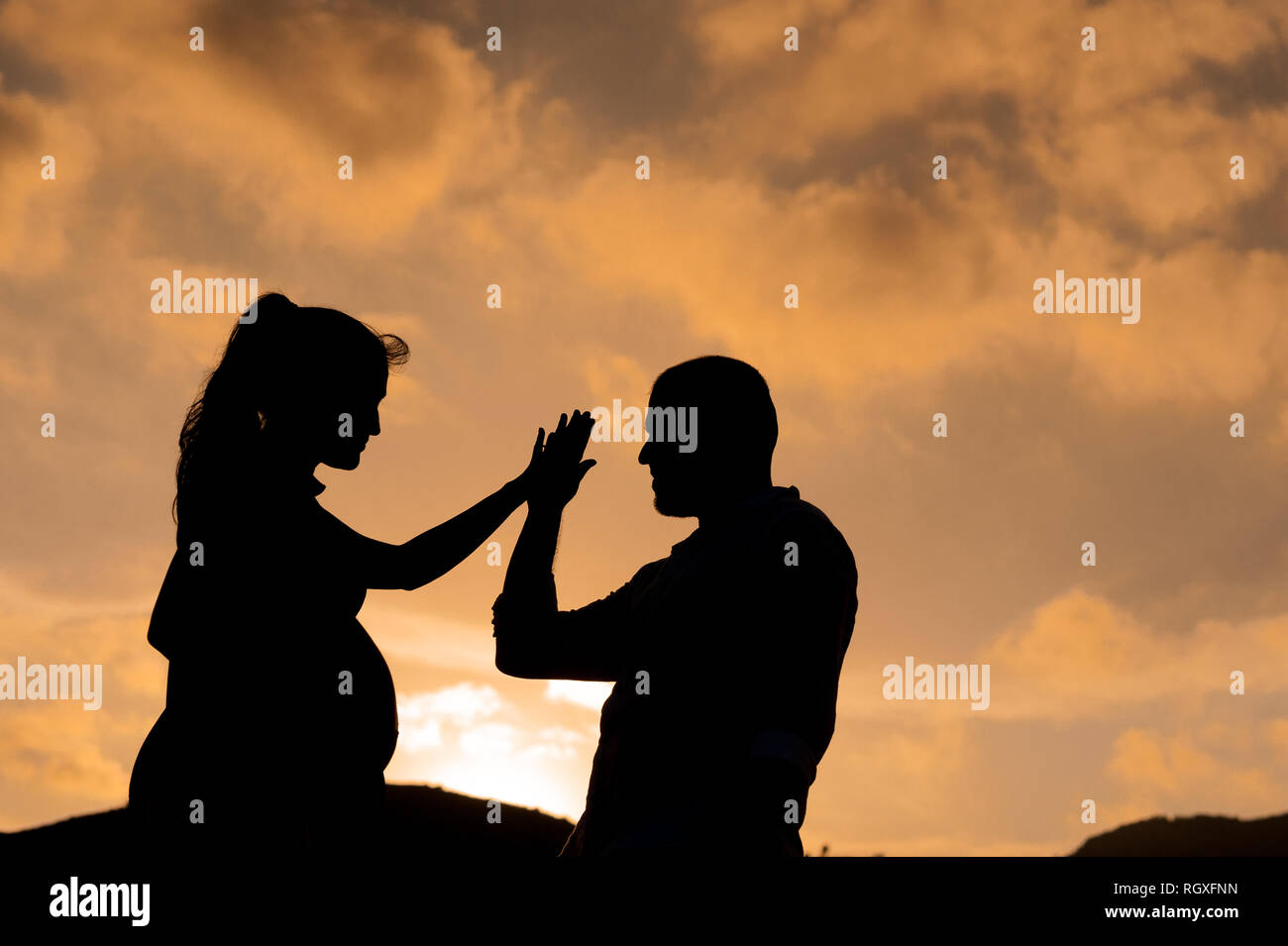 Silhouette Of Young Couple In Love Looking At Each Other At Sunset With Woman Pregnant Holding Hands Stock Photo Alamy Silhouette Of Young Couple In Love Looking At Each Other At Sunset With Woman Pregnant Holding Hands Stock Photo Alamy