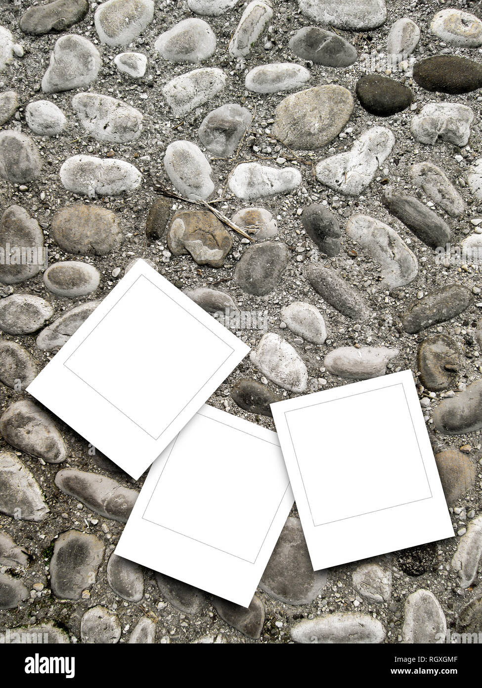 Three blank square instant photo frames on pebble background Stock Photo