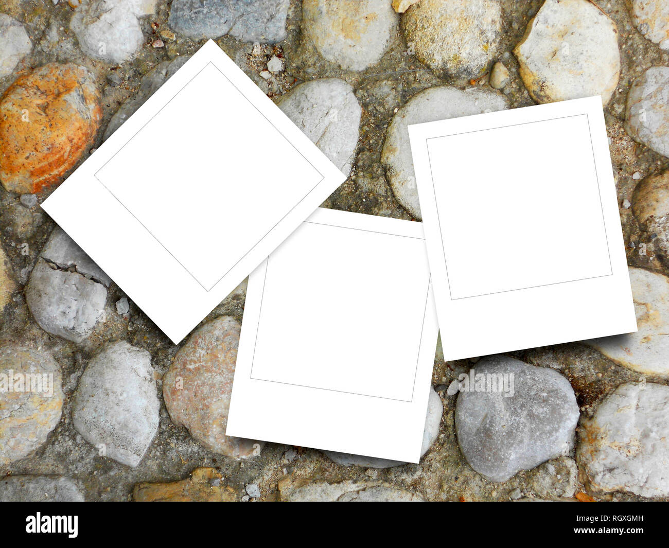 Three blank square instant photo frames on brown pebble background Stock Photo