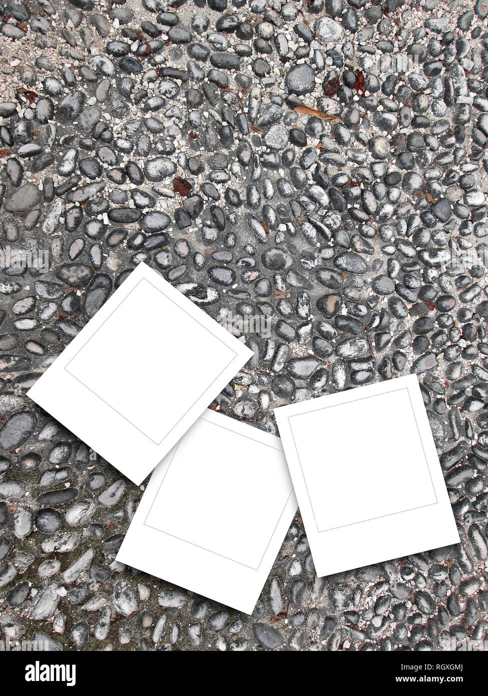 Three blank square instant photo frames on grey pebble background Stock Photo