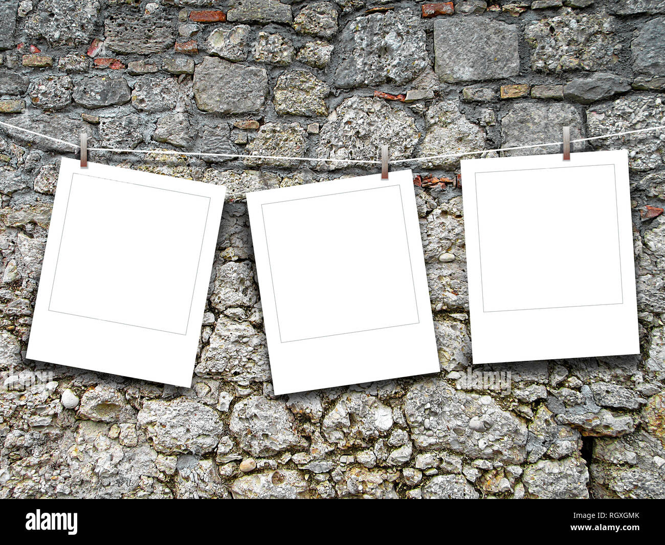 Three blank square instant photo frames against old stone wall background Stock Photo