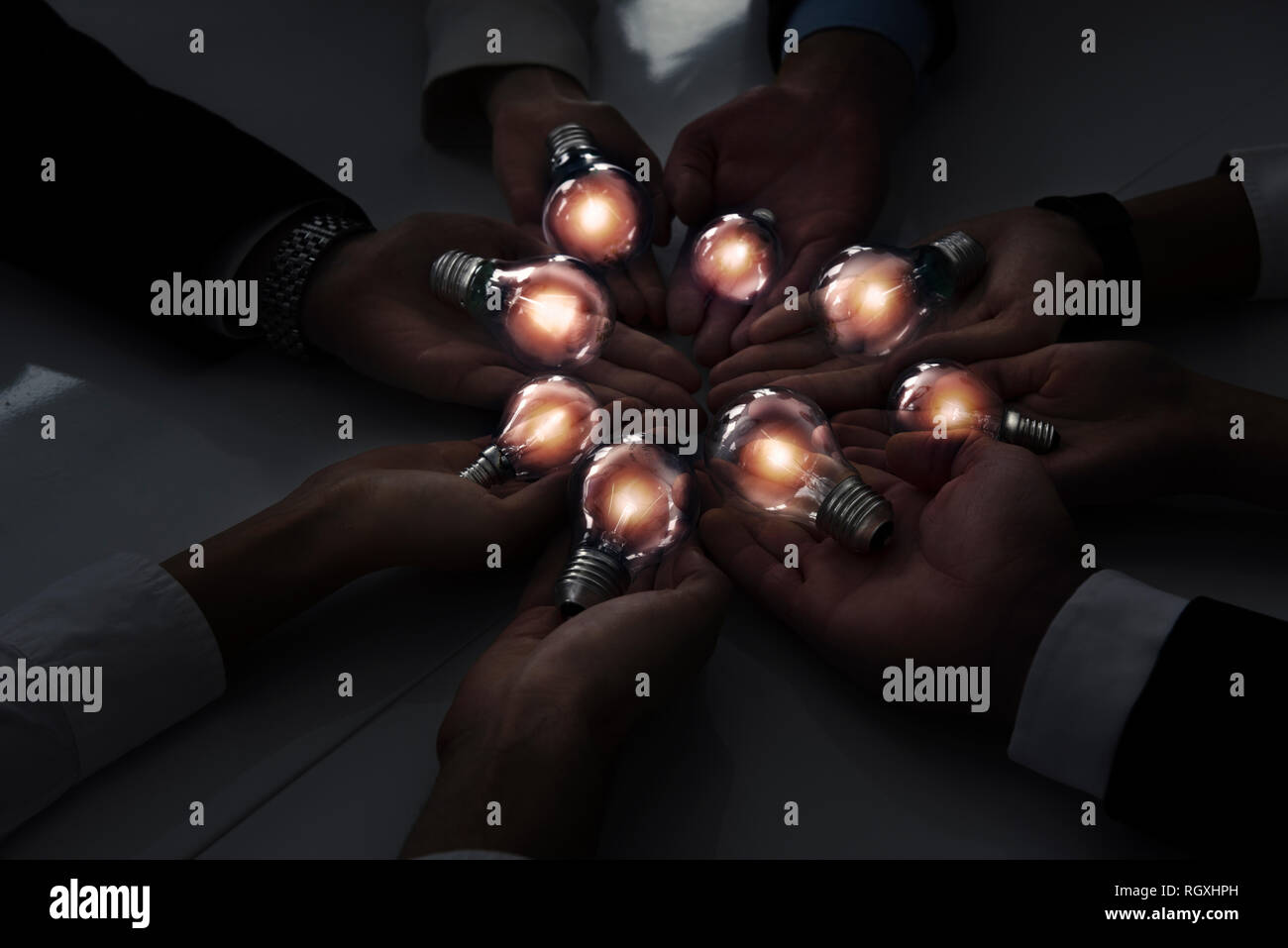 Teamwork and brainstorming concept with businessmen that share an idea with a lamp. Concept of startup Stock Photo